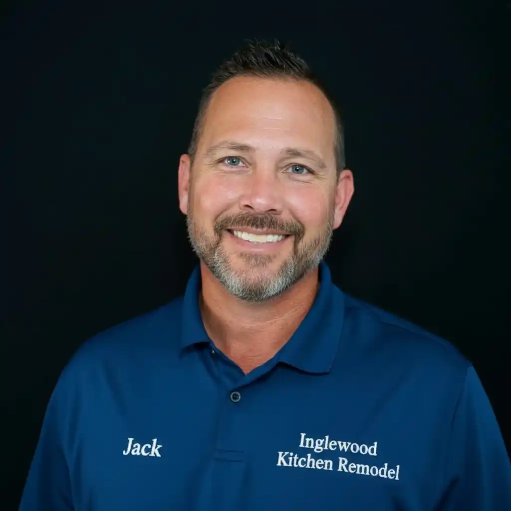 Jack Thomas, owner of Inglewood Kitchen Remodel, standing in front of company signage